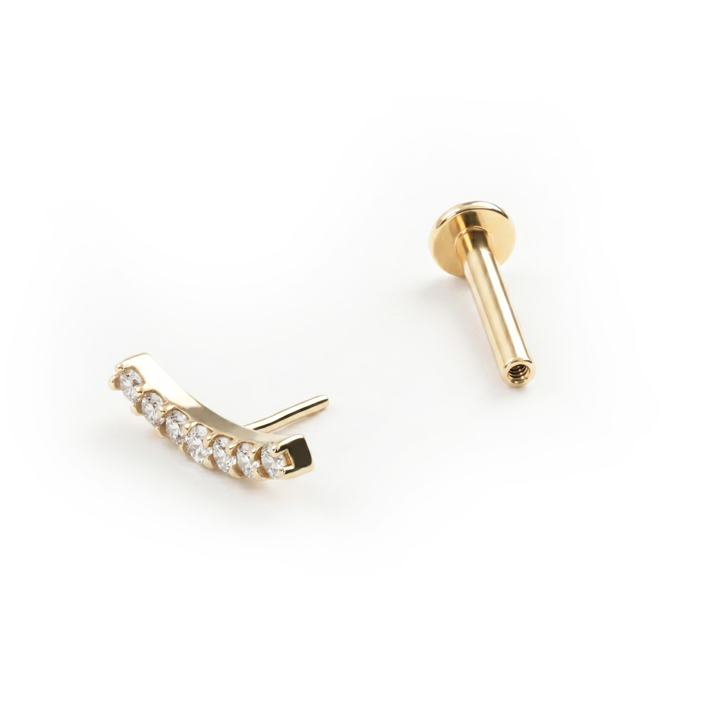 Push-in labret af 14 karat guld med bue af sten