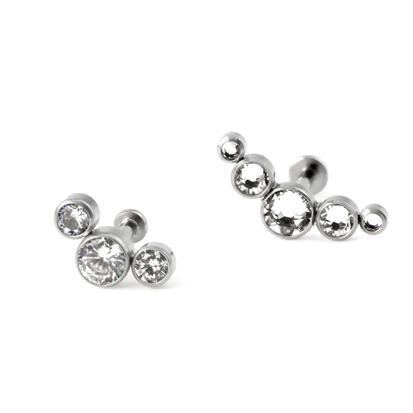 Labret af titanium med push-in top i forskellige farver indfattet sten